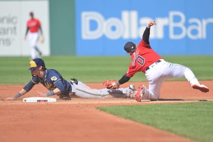 Jun 24, 2023; Cleveland, Ohio, USA; Milwaukee Brewers left fielder Christian Yelich (22) steals second as Cleveland Guardians second baseman Andres Gimenez (0) is late with the tag during the third inning at Progressive Field. Mandatory Credit: Ken Blaze-USA TODAY Sports