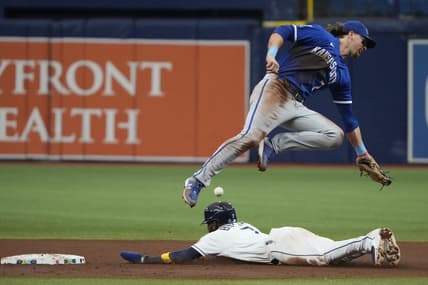 Jun 24, 2023; St. Petersburg, Florida, USA; Tampa Bay Rays right fielder Vidal Brujan (7) steals second base as Kansas City Royals shortstop Bobby Witt Jr. (7) fails to make the catch and tag during the fourth inning at Tropicana Field. Mandatory Credit: Dave Nelson-USA TODAY Sports
