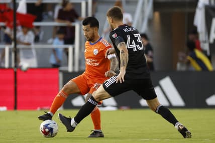 Jun 24, 2023; Washington, District of Columbia, USA; FC Cincinnati midfielder Luciano Acosta (10) dribbles the ball as D.C. United midfielder Mateusz Klich (43) defends. in the first half at Audi Field. Mandatory Credit: Geoff Burke-USA TODAY Sports