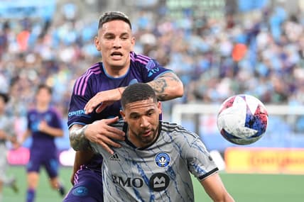 Jun 24, 2023; Charlotte, North Carolina, USA;  Charlotte FC forward Enzo Copetti (9) and CF Montr  al defender George Campbell (24) fight for the ball in the first half at Bank of America Stadium. Mandatory Credit: Bob Donnan-USA TODAY Sports