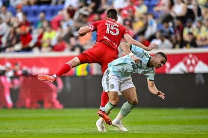 Jun 24, 2023; Harrison, New Jersey, USA; New York Red Bulls defender Sean Nealis (15) battles Atlanta United forward Giorgos Giakoumakis (7) during the first half at Red Bull Arena. Mandatory Credit: John Jones-USA TODAY Sports