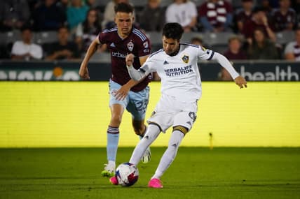 Jun 24, 2023; Commerce City, Colorado, USA; Los Angeles Galaxy midfielder Riqui Puig (6) controls the ball against Colorado Rapids midfielder Cole Bassett (23) during the second half at Dick's Sporting Goods Park. Mandatory Credit: Ron Chenoy-USA TODAY Sports
