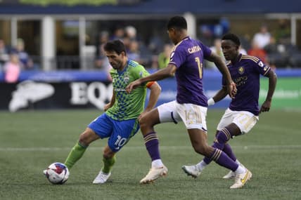 Jun 24, 2023; Seattle, Washington, USA; Seattle Sounders midfielder Nicolas Lodeiro (10) dribbles the ball against Orlando City midfielder Wilder Cartagena (16) during the first half at Lumen Field. Mandatory Credit: Steven Bisig-USA TODAY Sports