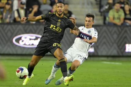 Jun 24, 2023; Los Angeles, California, USA; Los Angeles FC forward Denis Bouanga (99) and Vancouver Whitecaps midfielder Andres Cubas (20) go for the ball in the first half at BMO Stadium. Mandatory Credit: Jayne Kamin-Oncea-USA TODAY Sports