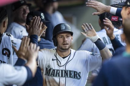 Jun 26, 2023; Seattle, Washington, USA; Seattle Mariners left fielder Jarred Kelenic (10) is congratulated by teammates in the dugout after scoring a run against the Washington Nationals during the fifth inning at T-Mobile Park. Mandatory Credit: Stephen Brashear-USA TODAY Sports