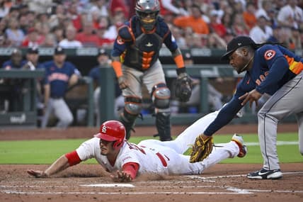 Jun 27, 2023; St. Louis, Missouri, USA;  St. Louis Cardinals third baseman Nolan Arenado (28) slides in at homeplate as Houston Astros starting pitcher Framber Valdez (59) attempts to apply the tag during the fifth inning at Busch Stadium. Arenado was called out on the play but the call was overturned after a successful challenge by the Cardinals. Mandatory Credit: Jeff Curry-USA TODAY Sports
