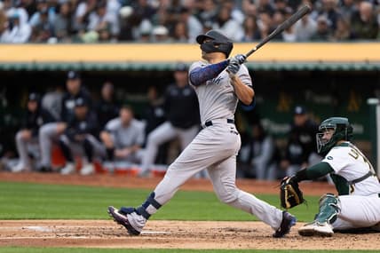 Jun 28, 2023; Oakland, California, USA;  New York Yankees designated hitter Giancarlo Stanton (27) hits a solo home run during the fourth inning against the Oakland Athletics at Oakland-Alameda County Coliseum. Mandatory Credit: Stan Szeto-USA TODAY Sports