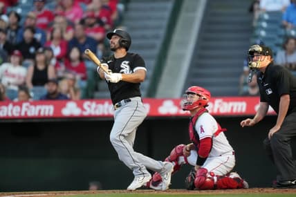 Jun 28, 2023; Anaheim, California, USA; Chicago White Sox catcher Seby Zavala (44) follows through on a home run in the second inning as Los Angeles Angels catcher Chad Wallach (35) and home plate umpire Chad Whiston watch at Angel Stadium. Mandatory Credit: Kirby Lee-USA TODAY Sports