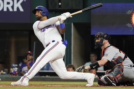 Jun 29, 2023; Arlington, Texas, USA; Texas Rangers shortstop Ezequiel Duran (20) follows thru on a solo home run during the fourth inning against the Detroit Tigers at Globe Life Field. Mandatory Credit: Raymond Carlin III-USA TODAY Sports