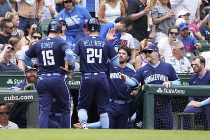 Jun 30, 2023; Chicago, Illinois, USA; Chicago Cubs center fielder Cody Bellinger (24) and catcher Yan Gomes (15) are greeted after scoring against the Cleveland Guardians during the fourth inning at Wrigley Field. Mandatory Credit: David Banks-USA TODAY Sports