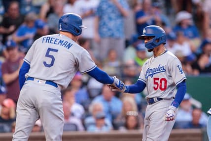 Jun 30, 2023; Kansas City, Missouri, USA;  Los Angeles Dodgers right fielder Mookie Betts (50) slaps hands with Los Angeles Dodgers first baseman Freddie Freeman (5) after scoring during the third inning against the Kansas City Royals at Kauffman Stadium. Mandatory Credit: William Purnell-USA TODAY Sports