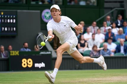 Jul 5, 2022; London, England, United Kingdom; Jannik Sinner (ITA) returns a shot against Novak Djokovic (SRB) during a quarterfinals mens singles match on Centre court at the 2022 Wimbledon Championships at All England Lawn Tennis and Croquet Club. Mandatory Credit: Peter van den Berg-USA TODAY Sports