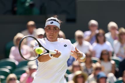 Jul 7, 2022; London, England, United Kingdom;  Ons Jabeur (TUN) returns a shot during  her semi finals women   s singles match against Tatjana Maria (GER) on Centre court at All England Lawn Tennis and Croquet Club. Mandatory Credit: Peter van den Berg-USA TODAY Sports