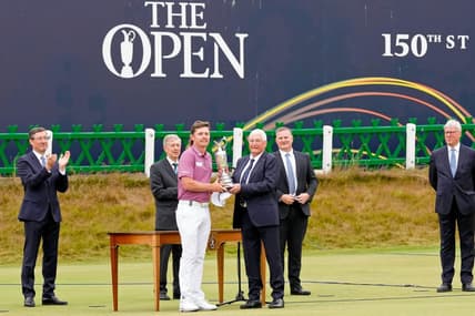 Jul 17, 2022; St. Andrews, SCT; Cameron Smith is presented the claret jug after winning the 150th Open Championship golf tournament at St. Andrews Old Course. Mandatory Credit: Michael Madrid-USA TODAY Sports