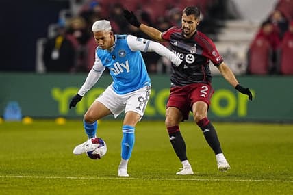 Apr 1, 2023; Toronto, Ontario, CAN; Charlotte FC forward Enzo Copetti (9) tries to control the ball against Toronto FC defender Matt Hedges (2) during the first half at BMO Field. Mandatory Credit: John E. Sokolowski-USA TODAY Sports