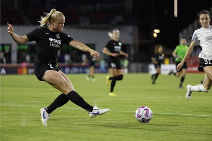 May 10, 2023; Washington, D.C., USA; Washington Spirit attacker Civana Kuhlmann (20) passes the ball as Orlando Pride defender Brianna Mart nez (32) defends in the second half of a UKG Challenge Cup match at Audi Field. Mandatory Credit: Geoff Burke-USA TODAY Sports