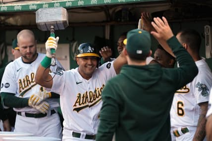 Jun 30, 2023; Oakland, California, USA; Oakland Athletics first baseman Carlos Perez (center) celebrates in the dugout while carrying a replica hammer after hitting a home run against the Chicago White Sox during the fifth inning at Oakland-Alameda County Coliseum. Mandatory Credit: Darren Yamashita-USA TODAY Sports