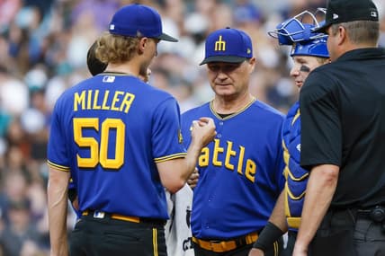 Jun 30, 2023; Seattle, Washington, USA; Seattle Mariners manager Scott Servais (middle) talks with starting pitcher Bryce Miller (50) during a potential injury analysis in the third inning against the Tampa Bay Rays at T-Mobile Park. Mandatory Credit: Joe Nicholson-USA TODAY Sports