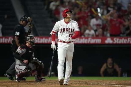 Jun 30, 2023; Anaheim, California, USA; Los Angeles Angels star Shohei Ohtani (17) follows through on a solo home run in the sixth inning as Arizona Diamondbacks catcher Carson Kelly (18) and home plate umpire Ramon De Jesus watch at Angel Stadium. Mandatory Credit: Kirby Lee-USA TODAY Sports