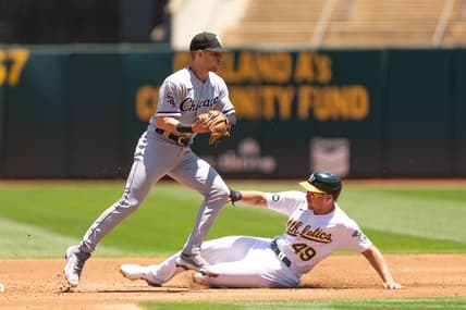 Jul 1, 2023; Oakland, California, USA;  Chicago White Sox shortstop Zach Remillard (28) force tags Oakland Athletics first baseman Ryan Noda (49) during the second inning at Oakland-Alameda County Coliseum. Mandatory Credit: Stan Szeto-USA TODAY Sports