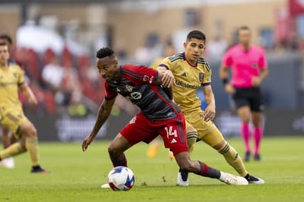 Jul 1, 2023; Toronto, Ontario, CAN;  Toronto FC midfielder Mark-Anthony Kaye (14) battles against Real Salt Lake forward Jefferson Savarino (10) during the first half at BMO Field. Mandatory Credit: Kevin Sousa-USA TODAY Sports