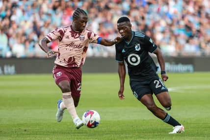 July 1, 2023; Saint Paul, Minnesota, USA; Portland Timbers midfielder Diego Char  (21) and Minnesota United forward Bongokuhle Hlongwane (21) battle for the ball during the first half at Allianz Field. Mandatory Credit: Matt Krohn-USA TODAY Sports