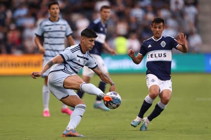 Jul 1, 2023; Kansas City, Kansas, USA; Sporting Kansas City forward Alan Pulido (9) controls the ball against Vancouver Whitecaps midfielder Andres Cubas (20) during the first half at Children's Mercy Park. Mandatory Credit: William Purnell-USA TODAY Sports