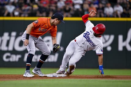 Jul 3, 2023; Arlington, Texas, USA; Texas Rangers second baseman Marcus Semien (2) steals second base against Houston Astros shortstop Mauricio Dubon (14) during the third inning at Globe Life Field. Mandatory Credit: Jerome Miron-USA TODAY Sports