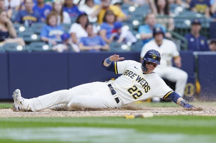 Jul 3, 2023; Milwaukee, Wisconsin, USA;  Milwaukee Brewers left fielder Christian Yelich (22) slides into home plate to score a run during the eighth inning against the Chicago Cubs at American Family Field. Mandatory Credit: Jeff Hanisch-USA TODAY Sports