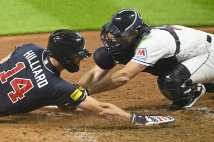 Jul 4, 2023; Cleveland, Ohio, USA; Cleveland Guardians catcher David Fry (12) tags out Atlanta Braves center fielder Sam Hilliard (14) in the tenth inning at Progressive Field. Mandatory Credit: David Richard-USA TODAY Sports