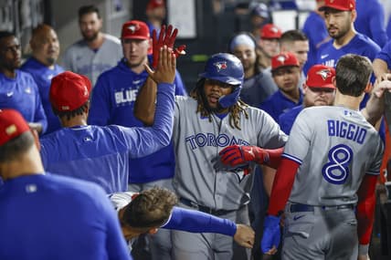 Jul 4, 2023; Chicago, Illinois, USA; Toronto Blue Jays first baseman Vladimir Guerrero Jr. (27) celebrates with teammates after hitting a two-run home run against the Chicago White Sox during the eighth inning at Guaranteed Rate Field. Mandatory Credit: Kamil Krzaczynski-USA TODAY Sports