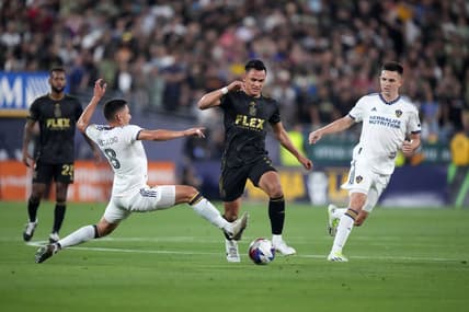 Jul 4, 2023; Los Angeles, California, USA; LAFC defender Denil Maldonado (2) and LA Galaxy midfielder Marco Delgado (8) battle for the ball in the first half at the Rose Bowl. Mandatory Credit: Kirby Lee-USA TODAY Sports