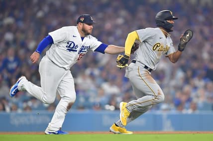 July 4, 2023; Los Angeles, California, USA; Pittsburgh Pirates right fielder Josh Palacios (54) is tagged out on a rundown by Los Angeles Dodgers third baseman Max Muncy (13) during the ninth inning at Dodger Stadium. Mandatory Credit: Gary A. Vasquez-USA TODAY Sports