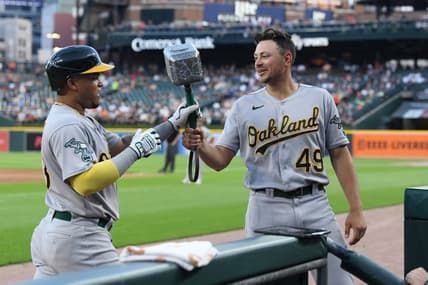 Jul 5, 2023; Detroit, Michigan, USA; Oakland Athletics first baseman Ryan Noda (49) (right) hands Thor's hammer to Oakland Athletics designated hitter Jordan Diaz (13) after Diaz hit a home run against the Detroit Tigers in the eighth inning at Comerica Park. Mandatory Credit: Lon Horwedel-USA TODAY Sports