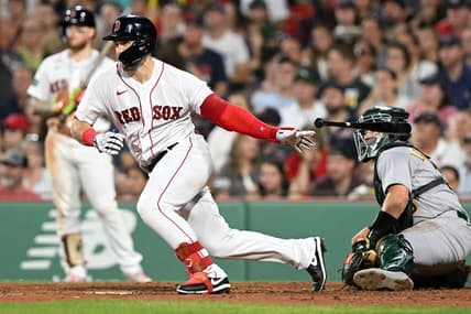 Jul 7, 2023; Boston, Massachusetts, USA; Boston Red Sox center fielder Adam Duvall (18) hits a RBI single against the Oakland Athletics during the seventh inning at Fenway Park. Mandatory Credit: Brian Fluharty-USA TODAY Sports