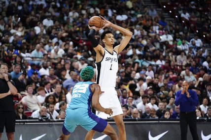 Jul 7, 2023; Las Vegas, NV, USA; San Antonio Spurs forward Victor Wembanyama (1) controls the ball against Charlotte Hornets forward/center Kai Jones (23) during the second half at Thomas & Mack Center. Mandatory Credit: Lucas Peltier-USA TODAY Sports