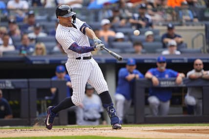 Jul 8, 2023; Bronx, New York, USA; New York Yankees right fielder Giancarlo Stanton (27) hits a home run against the Chicago Cubs during the first inning at Yankee Stadium. Mandatory Credit: Gregory Fisher-USA TODAY Sports