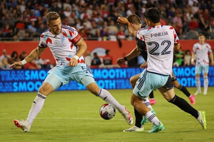Jul 8, 2023; Chicago, Illinois, USA; Chicago Fire defender Rafael Czichos (5) and defender Mauricio Pineda (22) defend Nashville SC midfielder Alex Muyl (19) during the second half at Soldier Field. Mandatory Credit: Jon Durr-USA TODAY Sports