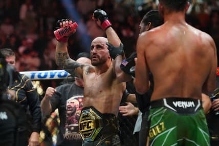 Jul 8, 2023; Las Vegas, Nevada, USA; Alexander Volkanovski (red gloves) reacts after defeating Yair Rodriguez (blue gloves) during UFC 290 at T-Mobile Arena. Mandatory Credit: Stephen R. Sylvanie-USA TODAY Sports