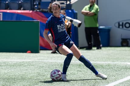 Jul 1, 2023; Seattle, Washington, USA; OL Reign defender Phoebe McClernon (21) gets control of the ball against Racing Louisville at Lumen Field. Mandatory Credit: Stephen Brashear-USA TODAY Sports