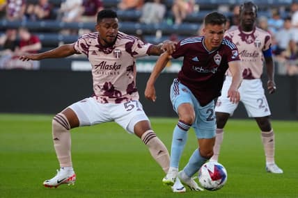 Jul 12, 2023; Commerce City, Colorado, USA; Colorado Rapids midfielder Cole Bassett (23) and Portland Timbers midfielder Victor Griffith (57) battle for the ball during the second half at Dick's Sporting Goods Park. Mandatory Credit: Ron Chenoy-USA TODAY Sports