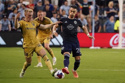 Jul 12, 2023; Kansas City, Kansas, USA; Real Salt Lake defender Jasper Loffelsend (28) fights for the ball against Sporting Kansas City midfielder Erik Thommy (26) during the first half at Children's Mercy Park. Mandatory Credit: Denny Medley-USA TODAY Sports