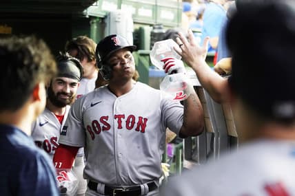 Jul 14, 2023; Chicago, Illinois, USA; Boston Red Sox third baseman Rafael Devers (11) celebrates with teammates in the dugout after hitting a home run against the Chicago Cubs during the third inning at Wrigley Field. Mandatory Credit: David Banks-USA TODAY Sports