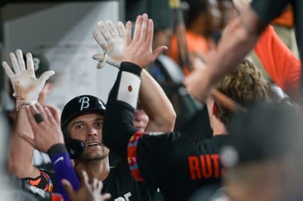 Jul 14, 2023; Baltimore, Maryland, USA;  Baltimore Orioles second baseman Adam Frazier (12) high fives teammates after hitting a fourth  inning solo home run against the Miami Marlins at Oriole Park at Camden Yards. Mandatory Credit: Tommy Gilligan-USA TODAY Sports