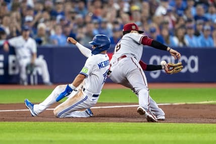 Jul 15, 2023; Toronto, Ontario, CAN; Toronto Blue Jays second baseman Whit Merrifield (15) slides into third base by Arizona Diamondbacks third baseman Emmanuel Rivera (15) during the second inning at Rogers Centre. Mandatory Credit: Kevin Sousa-USA TODAY Sports