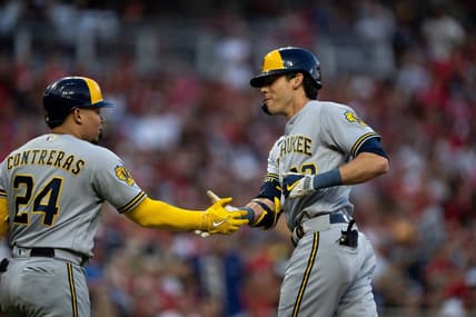 Milwaukee Brewers designated hitter Christian Yelich (22) celebrates with Milwaukee Brewers catcher William Contreras (24) after hitting a solo home run in the first inning of the MLB baseball game between the Cincinnati Reds and the Milwaukee Brewers at Great American Ball Park in Cincinnati on Saturday, July 15, 2023.