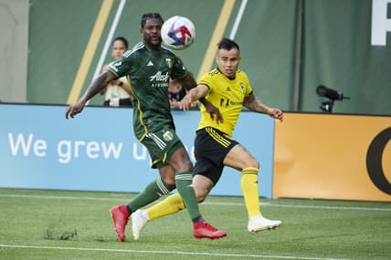 Jul 15, 2023; Portland, Oregon, USA; Columbus Crew midfielder Lucas Zelarrayan (10) crosses the ball during the first half against Portland Timbers forward Dairon Asprilla (27) at Providence Park. Mandatory Credit: Troy Wayrynen-USA TODAY Sports