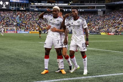Jul 15, 2023; Seattle, Washington, USA; FC Dallas forward Bernard Kamungo (77) celebrates with forward Jader Obrian (8) after scoring a goal against the Seattle Sounders FC during the first half at Lumen Field. Mandatory Credit: Joe Nicholson-USA TODAY Sports