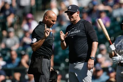 Jul 16, 2023; Denver, Colorado, USA; New York Yankees manager Aaron Boone (17) talks with home plate umpire Vic Carapazza (19) in the ninth inning against the Colorado Rockies at Coors Field. Mandatory Credit: Isaiah J. Downing-USA TODAY Sports