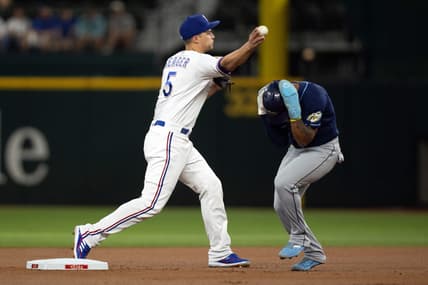 Jul 17, 2023; Arlington, Texas, USA; Texas Rangers shortstop Corey Seager (5) attempts to turn a double play as Tampa Bay Rays shortstop Wander Franco (5) runs to second base in the first inning at Globe Life Field. Mandatory Credit: Tim Heitman-USA TODAY Sports